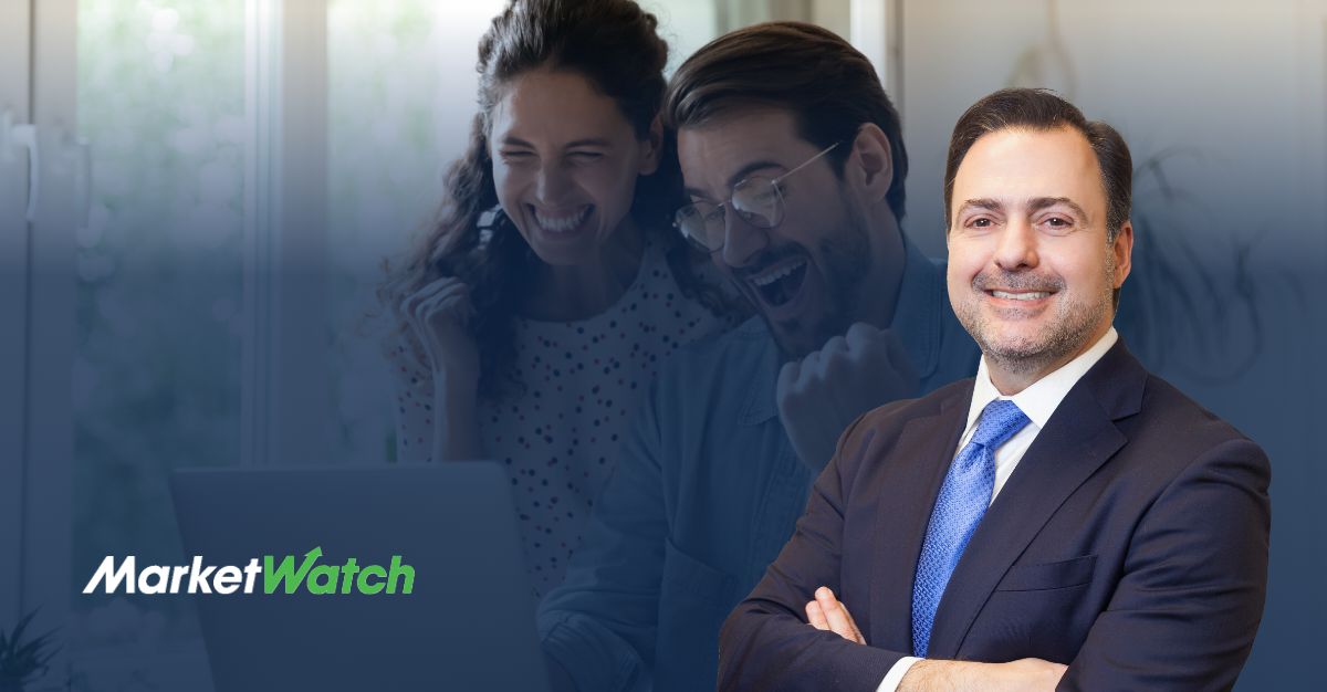 Attorney Asher Rubinstein stands confidently in the foreground, smiling in a suit and blue tie. In the background, a joyful couple raises their fists in celebration while looking at a laptop screen. The MarketWatch logo appears in the bottom-left corner.