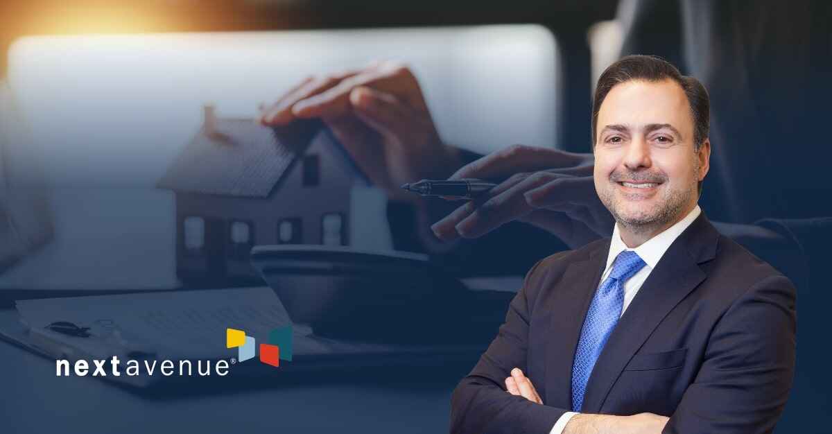 Asher Rubinstein in the right foreground of an image of hands holding a pen next to a calculator and miniature house model and the GDB logo in the bottom left corner