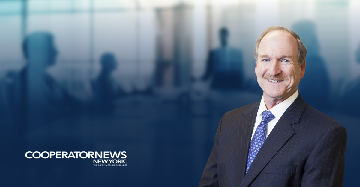 David Berkey standing in the foreground wearing a dark pinstripe suit, white shirt, and blue patterned tie, smiling at the camera. In the background is a blurred image of people meeting in a boardroom, with the CooperatorNews New York logo in the bottom left corner.