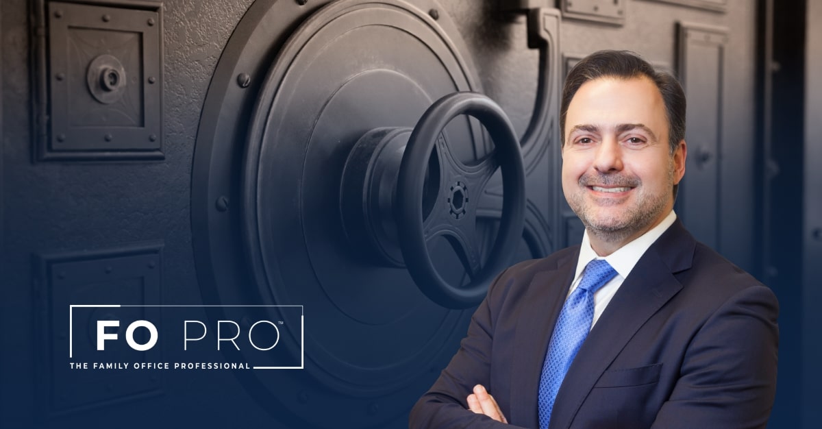 Asher Rubinstein in the foreground of an Image of a bank vault door.
