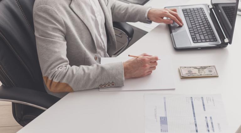 male accountant works at pc in office