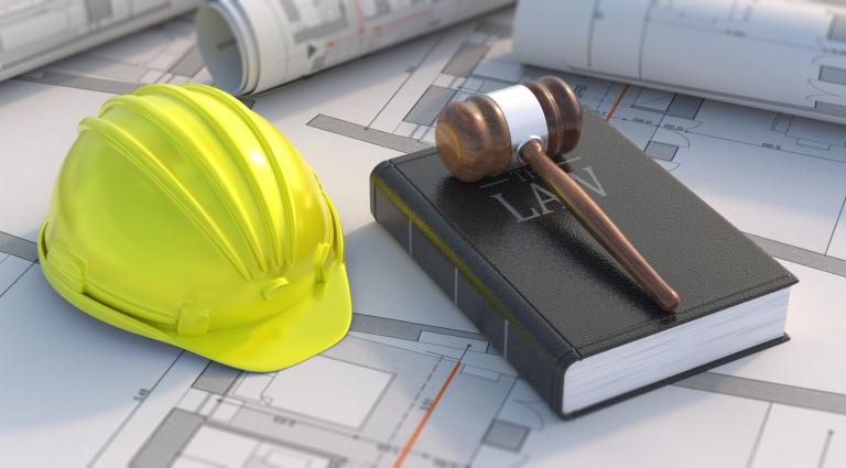 construction hat next to a judge gavel