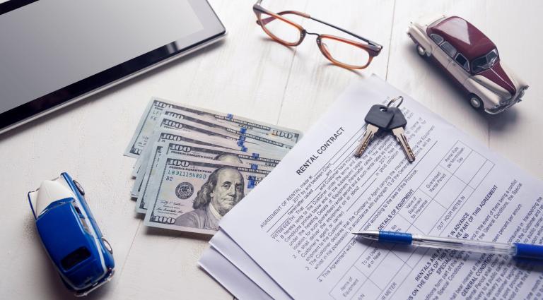 rent contract with key and money on office table