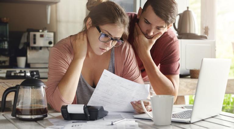 couple looking over a document in the kitchen