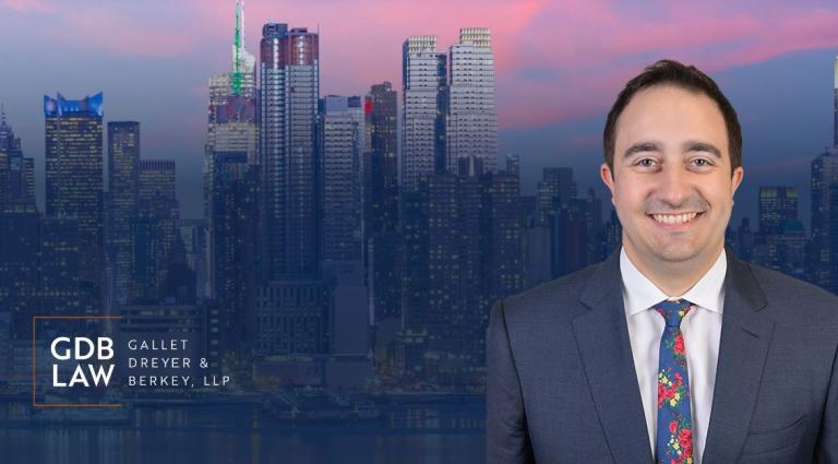 Nicholas Sorrentino in the foreground of an image of skyscrapers at nighttime