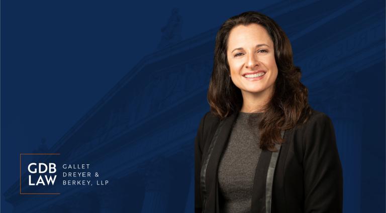 Headshot of Beth M. Gazes on a blue background with the GDB logo in the bottom left foreground.