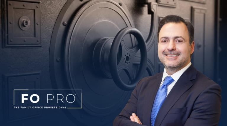 Asher Rubinstein in the foreground of an Image of a bank vault door.