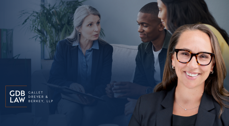 Atty Bruggemann smiling in the foreground, with a blurred background showing a couple sitting down talking to a lawyer.