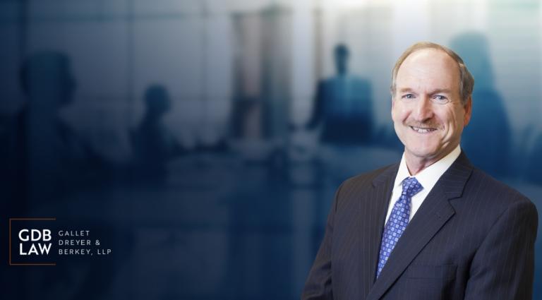 Headshot of David Berkey in the foreground of a blurred boardroom background with silhouettes of people in a meeting and the GDB logo in the bottom left corner..