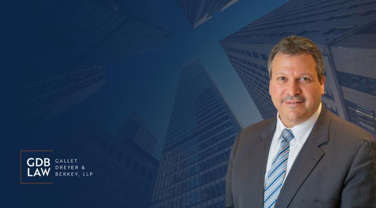 Headshot of Joseph Farca in the foreground of a blue background of skyscrapers.