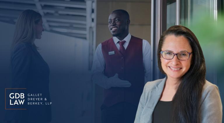 Headshot of Beth M. Gazes in the foreground. In the background, a building staff member in a vest gestures while speaking with a woman near a doorway, suggesting service or entry to a building. The GDB Law (Gallet, Dreyer & Berkey, LLP) logo appears on the left over a blue gradient.
