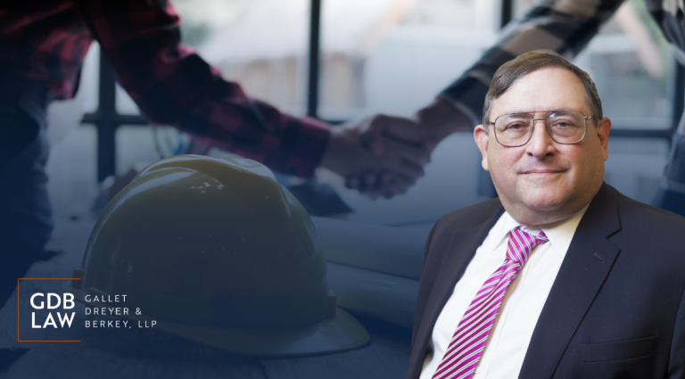 Headshot of Eugene H. Goldberg in front of a blurred background of a handshake over construction plans and a hard hat. The GDB Law (Gallet Dreyer & Berkey, LLP) logo appears on then bottom left.