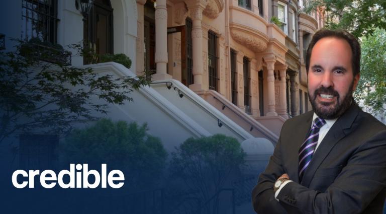 Headshot of Scott Smiler standing with arms crossed in front of brownstone buildings, with the Credible logo displayed in the lower left corner.
