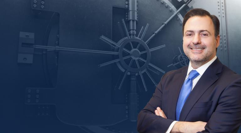 Asher Rubinstein Headshot in front of a bank vault