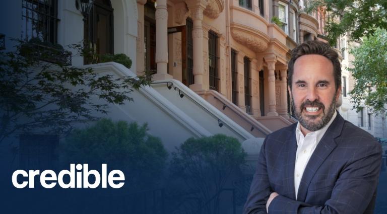Headshot of Scott Smiler standing with arms crossed in front of brownstone buildings, with the Credible logo displayed in the lower left corner.